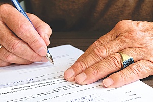 a man signing an H1B RFE petition