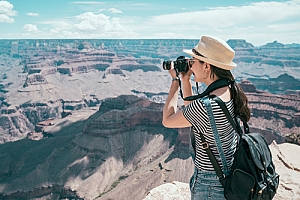 Tourist on B2 Visa taking photo of Grand Canyon