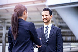 man and woman shaking hands at an interview