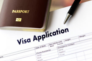 passport lays on top of q visa application