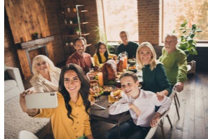 full family gathering eight people woman mother hold telephone