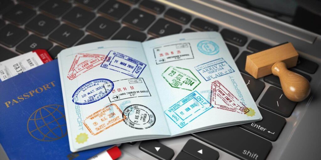 passport with visa stamps with airline boarding pass tickets and stamper
