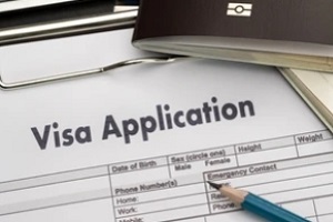 visa application form on clipboard with pencil and visa