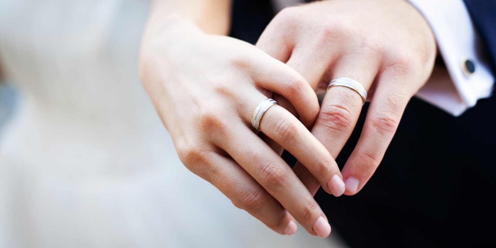 newly wed couple hands with wedding rings