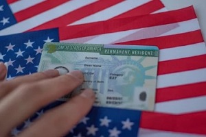 permanent residency card on U.S. flag
