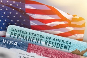 usa flag behind permanent residency card and visa