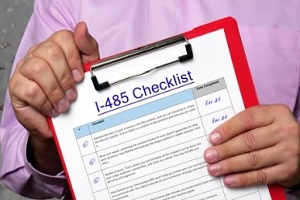 man holding clipboard with i 485 checklist