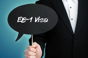 EB-1 visa lawyer holds the sign of a speech bubble in his hand