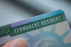 close up view of fragment of permanent resident card (Green) card of USA on blurred background