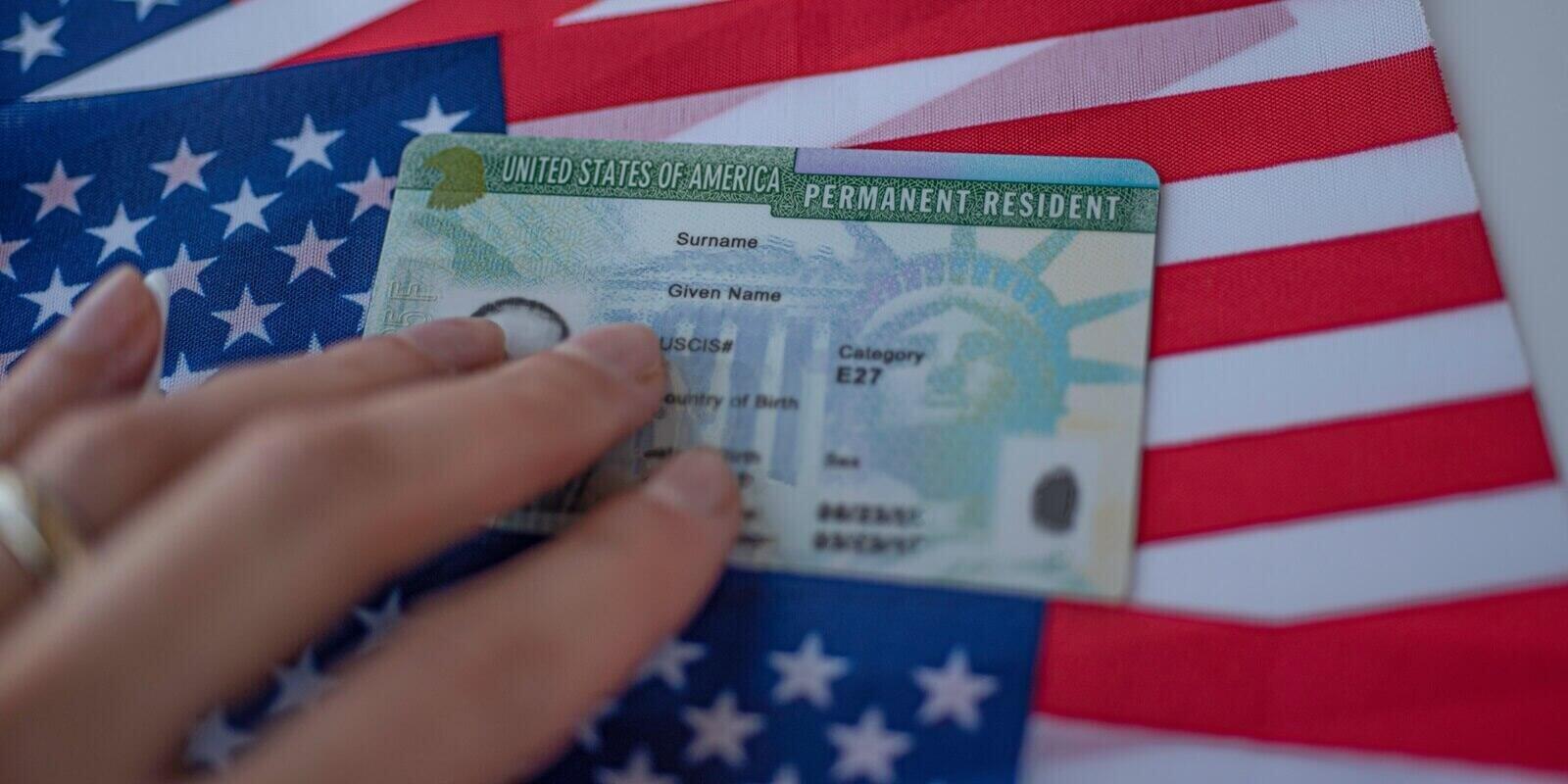permanent resident green card of inited states of america on flag of USA